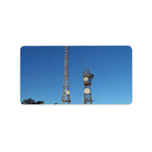 Twin communication towers against blue sky custom address label