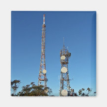 Twin communication towers against blue sky fridge magnets