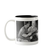 Two couples on beach sitting around campfire coffee mug