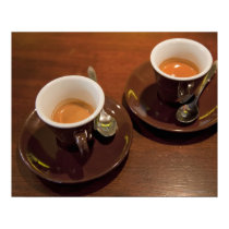two cups of freshly brewed espresso coffee on a posters