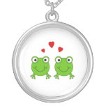 Two green frogs with red hearts. jewelry