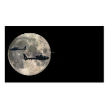two helicopters silhouetted by a full moon business card