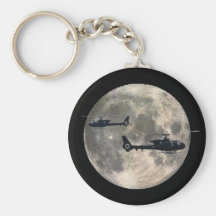 two helicopters silhouetted by a full moon key chain