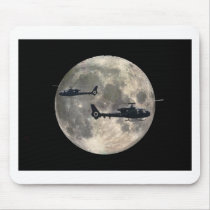 two helicopters silhouetted by a full moon