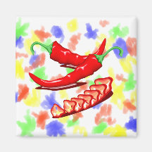 Two red chili peppers one cut up also refrigerator magnets