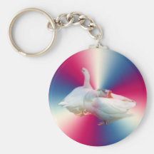 two white geese in fancy backgound. key chains