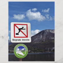 Waterscape with warning sign against the mountain flyers