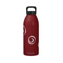 White paint swirls on red water bottles