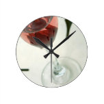 Wine glass with flower petals inside round wall clocks