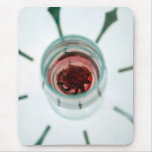 Wine glass with flower petals inside mouse pad