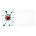 Wine glass with flower petals inside photo greeting card