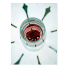 Wine glass with flower petals inside postcard