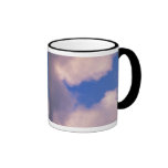 Wispy clouds against blue sky mugs