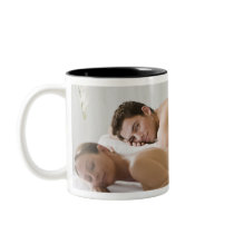woman and man lying on massage benches mug