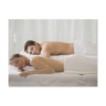 woman and man lying on massage benches postcards