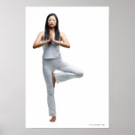 Woman standing in yoga position posters