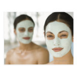 Women smiling in beauty mud masks post card