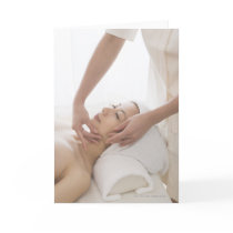 Young woman having facial massage card