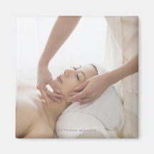 Young woman having facial massage fridge magnet