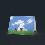 18th birthday golf ball in grass card<br><div class="desc">White golf ball in green grass with golf club and sky background for 18th birthday.</div>
