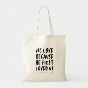 1 John 4:19 We love because He first loved us Tote Bag