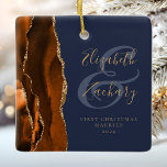 1st Christmas Married Burnt Orange Agate Navy Blue Ceramic Ornament<br><div class="desc">This elegant modern ornament features a burnt orange watercolor agate design trimmed with faux gold glitter. Easily customize the gold-coloured text on a navy blue background, with the names of the bride and groom in whimsical handwriting calligraphy over a large ampersand. The words "First Christmas Married" appear in serif font...</div>