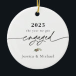 2025 Engaged Ornament | Modern Photo Keepsake<br><div class="desc">Commemorate your engagement with this elegant 2025 “the year we got engaged” ornament, featuring modern calligraphy typography and a delicate winter greenery accent. Personalize with your names and upload your favorite photo on the back to create a keepsake you’ll treasure every holiday season. Each ornament is printed in high quality...</div>