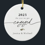 2025 Engaged Ornament | Modern Photo Keepsake<br><div class="desc">Commemorate your engagement with this elegant 2025 “the year we got engaged” ornament, featuring modern calligraphy typography and a delicate winter greenery accent. Personalize with your names and upload your favorite photo on the back to create a keepsake you’ll treasure every holiday season. Each ornament is printed in high quality...</div>