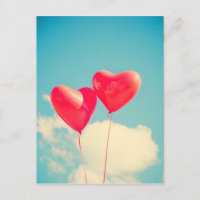 2 Bright Red Heart Shaped balloons Floating Upward