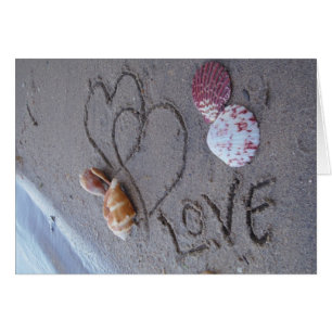 2 Coeurs dans le sable avec des coquilles avec Amo