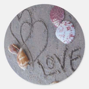 2 Hearts  in the sand with shells with Love Classic Round Sticker