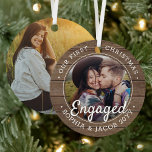 2 Photo First Christmas Engaged Rustic Faux Wood Metal Ornament<br><div class="desc">Celebrate the joyful 1st holiday of your engagement with a custom 2 photo "Our First Christmas Engaged" faux wood round metal ornament. All wording and images on this template are simple to personalize. (IMAGE & TEXT DESIGN TIPS: 1) To adjust position of wording, add spaces at beginning or end. 2)...</div>
