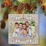 2 Photos Family Winter Greenery Tan Christmas Ceramic Ornament<br><div class="desc">This light tan Christmas ornament showcases an elegant white winter greenery illustration that frames the horizontal photo. The design offers space for 2 of your favourite pictures,  one on the front and another on the back. Personalize this lovely keepsake ornament with your family name and the year.</div>