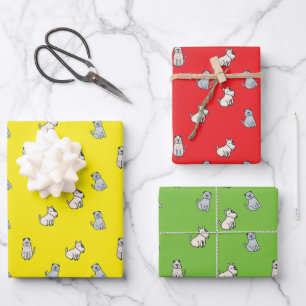 3 chiens mignons enveloppant du papier