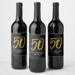 50th birthday party black gold favour wine label<br><div class="desc">Celebrate 50 years with this black and faux gold glitter wine label featuring a large stylized 50. Coordinates with the birthday and anniversary collection by Lea Delaveris Design. Works perfectly for a birthday or anniversary party favours,  table decor or as a gift.</div>