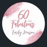 60 and Fabulous Pink Glitter 60th Birthday Classic Round Sticker<br><div class="desc">60 and Fabulous Pink Glitter 60th Birthday Stickers. Throw a stunning celebration with these “60 and Fabulous” pink glitter birthday stickers. Featuring sparkly faux-glitter brush strokes,  this elegant design is perfect for honouring a fabulous woman’s milestone birthday. Fully customizable to include a personal touch.</div>