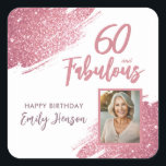 60 and Fabulous Pink Glitter Photo 60th Birthday Square Sticker<br><div class="desc">60 and Fabulous Pink Glitter Photo Surprise 60th Birthday Sticker. Stunning personalized stickers with “60 and Fabulous” text and pink glitter design. Featuring sparkly faux-glitter brush strokes, and space for a personal photo, this elegant design is perfect for honouring a fabulous woman’s milestone birthday. Fully customizable to include a personal...</div>