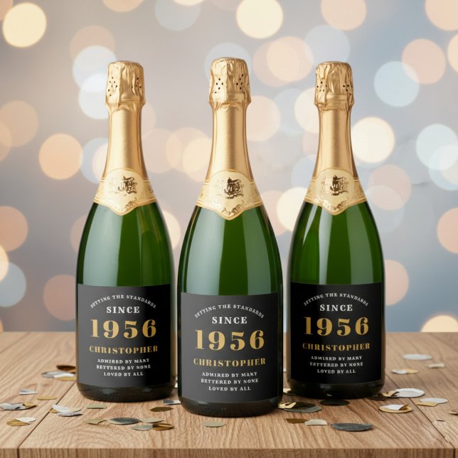 70th Birthday Born 1956 Add Name Black Gold Sparkling Wine Label (Born 1956 sparkling wine bottle labels. Background out of focus.)