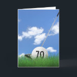 70th birthday golf ball in grass card<br><div class="desc">White golf ball in green grass with golf club and sky background for 70th birthday.
Age number on golf ball can be edited.</div>
