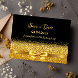 70th birthday party black gold bow save the date postcard<br><div class="desc">Elegant, classic, glamourous and feminine style 70th birthday party save the date postcard. A faux gold coloured ribbon and bow with faux golden glitter and sparkle, a bit of bling and luxury for a birthday. Black background. With the text: Save the Date on front written with a modern hand lettered...</div>