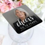 70th Birthday Party Photo Cheers White Script Square Paper Coaster<br><div class="desc">This custom 70th birthday paper coaster features the guest of honour's personalized photo,  name,  and birthday,  along with the word "Cheers" in elegant white calligraphy script. A dark screen helps make the text pop. A great way to celebrate someone who's turning seventy!</div>