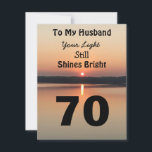 70th Husband Birthday Your Light Shines Sunset<br><div class="desc">Give a happy 70th birthday card to your husband to express your “You Still Shine Bright” sentiment. A bold design with a black and gold sunrise on a peaceful lake sends a message of encouragement and love. Turn over the card to read the endearing birthday verse of light and happiness...</div>