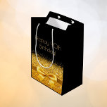 90th birthday black gold bow sparkle medium gift bag<br><div class="desc">Elegant,  classic,  glamourous and feminine style party gift bag for a 90 year old woman.  A gold coloured ribbon and bow with faux golden glitter and sparkle,  a bit of bling and luxury for a birthday.  Black background. Golden text: Happy 90th Birthday!</div>