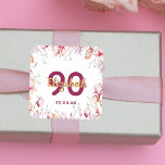 90th birthday pink magnolia flower frame on white square sticker<br><div class="desc">A sticker for a girly 90th birthday party. Branches with pink, purple and golden magnolia flowers. Elegant white background. Templates for a name, age 90 and a date. Date of birth or the date of the party/anniversary. Golden and burgundy coloured letters. The name is written with a modern hand lettered...</div>