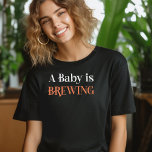 A Baby is Brewing in Spooky Cobweb Lettering T-Shirt<br><div class="desc">A Baby is Brewing shirt perfect for mommy-to-be or gender reveal hostess, fall pregnancy announcement or halloween themed baby shower. A Baby is Brewing is lettered in spooky cobweb lettering in orange and white. If you want to change the colours, you can edit using the design tool. Coordinating invitations and...</div>