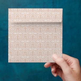 a beige and white chequered pattern on a white bac envelope