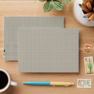 a beige background with a pattern of small squares envelope