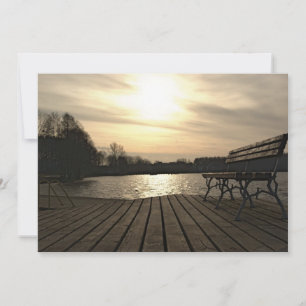 A bench on a wooden lake pier invitation