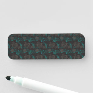 a black and green pattern with a black background name tag