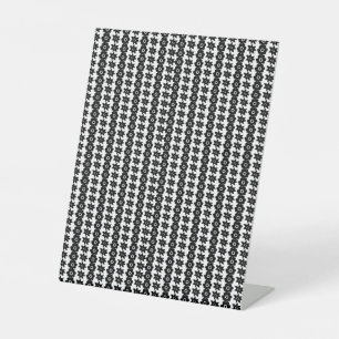 a black and white background with a lot of dots pedestal sign